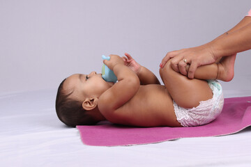 Indian Mother massaging her lovely baby.