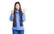 © Krakenimages.com - Young beautiful chinese woman wearing casual turtleneck sweater showing and pointing up with fingers number seven while smiling confident and happy.