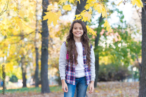 Fotomural happy girl in casual style spend time walking in autumn park enjoying good weath