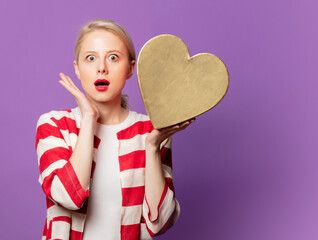 Sticker - Beautiful blonde in red jacket with heart shape gift box on purple background