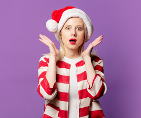 Sticker - Beautiful blonde in Christmas hat on puprle background