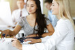 © Iryna - Group of business people discussing questions at meeting. Portrait of blond businesswoman in sunny office