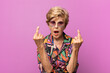 © kues1 - old pretty woman feeling provocative, aggressive and obscene, flipping the middle finger, with a rebellious attitude