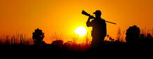 A Silhouette Of A Male Hunter Carrying A Shotgun. He Could Be Hunting Pheasant, Chukar, Partridge, Grouse, Dove Or Quail.