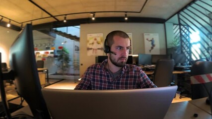 The programmer works at a computer in an empty office during quarantine.