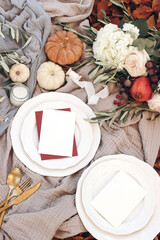 Poster - Autumn table setting with golden cutlery, olive branches and porcelain plates. Pumpkins and pomegranate fruit. Blank cards mockups. Fall, Thanksgiving and Rosh Hashanah celebration concept.
