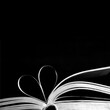 © izzzy71 - Book pages in the shape of heart on black background with copy space. Creative love background concept.