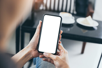 cell phone mockup blank white screen.woman hand holding texting using mobile on desk at coffee shop.background empty space for advertise.work people contact marketing business,technology