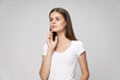 © SHOTPRIME STUDIO - The woman in a white T-shirt looks to the side attractive look long hair