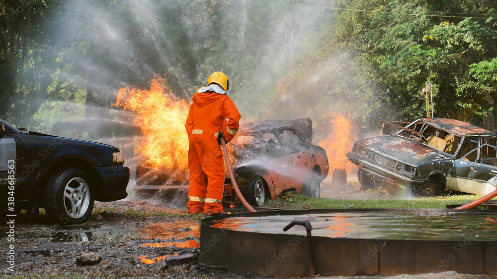 Firefighter fighting with flame using fire hose chemical water foam ...