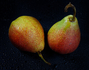 Very beautiful ripe pear on a black background.