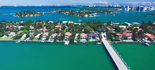 Wall Mural - Miami, Florida. Aerial view of Palm Island and surrounding skyline from drone on a sunny day, slow motion.