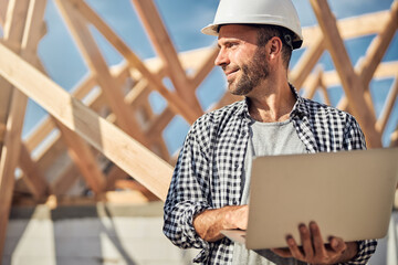 Busy field engineer controlling the process of house construction