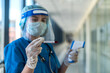 © RomanR - Female doctor using infrared thermometer to check body temperature in clinic