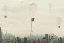 Surreal Moment Of A Woman Traveling On A Swing Carried By A Light Bulb Over A Metropolis