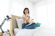© bigy9950 - White Shiba Inu Japanese pedigree adorable puppy staying on bed with young woman in bedroom. Pet Lover concept