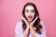 Photo portrait of happy amazed girl keeping hands near face with hydrating foam before applying makeup isolated on pink color background