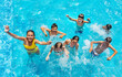 © Sergey Novikov - Group of many kids jump and play in swimming pool, splashing, lift hands smile view from above