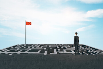 Poster - Businessman standing on maze with red flag