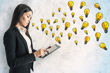 Poster - Young businesswoman using digital tablet with creative lightbulb