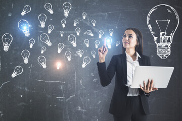 Poster - Attractive young businesswoman holding laptop with creative lamps sketch