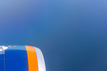 Wall Mural - view through the window of the plane, view of the engine. airplane flying over the sea of clouds. tr