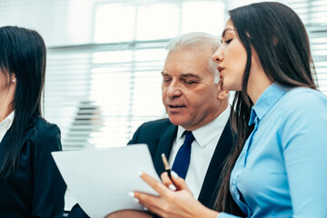 Wall Mural - close up. senior businessman discussing the document with his assistant.