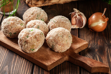 Wall Mural - Raw meatballs rolled in a crispy bun prepared for baking