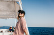 © velimir - young woman in a cap and shirt on a yacht on a trip