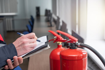 Wall Mural - engineer professional are checking a fire extinguisher using clipboard or checking industrial fire c