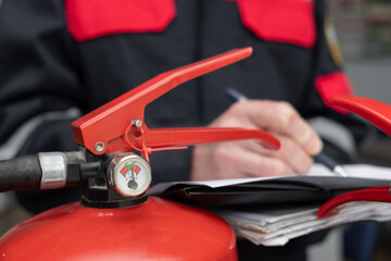 Wall Mural - engineer professional are checking a fire extinguisher using clipboard or checking industrial fire c