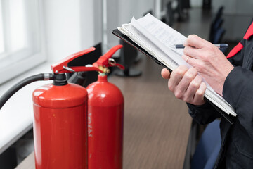 Engineer Professional are Checking A Fire Extinguisher Using Clipboard or checking Industrial fire control system,Fire Alarm controller, Fire notifier, Anti fire.System ready In the event of a fire.