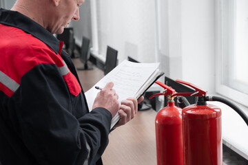 Wall Mural - engineer professional are checking a fire extinguisher using clipboard or checking industrial fire c