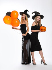 Sticker - Beautiful women in witch costumes with balloons and jack o'lantern on white background. Halloween party