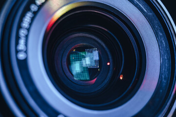 Poster - Close up Beautiful camera lens with multi colored light. Background pattern for design..