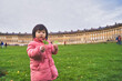 © Have a nice day  - cute adorable Asian kid travel holiday vacation in European country cold windy wearing coat winter at a national monumental building playing having fun enjoying lifestyle children fun happy joyful