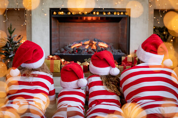 Canvas Print - Happy family with children near fireplace at Christmas