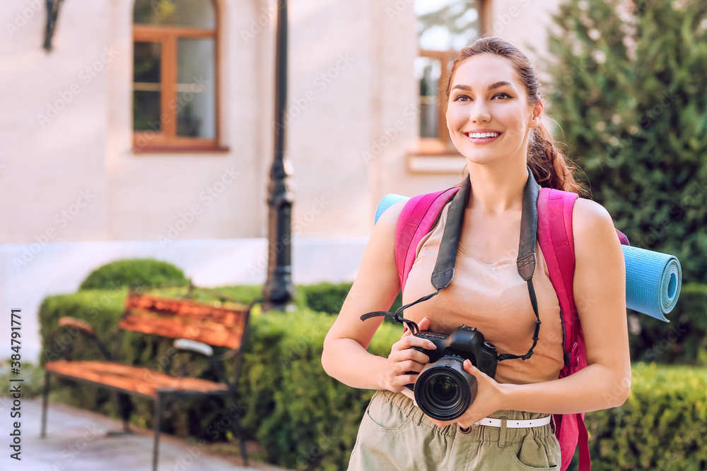 Female tourist with camera on city street