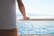 © Struzhkova Ilona - Sea, sun, white, blue, man, boat, summer. Young man staying on the board of a ship. Close up.