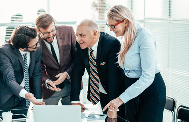 Wall Mural - happy employees discussing information coming to the office