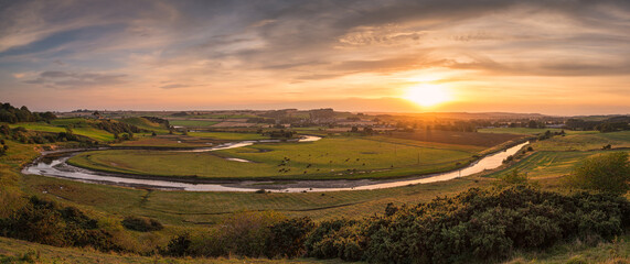 Wall Mural - sunset panorama of river aln, as it approaches the north sea at alnmouth, now tidal, it meanders thr