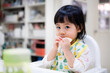 Baby eating bread. Asian baby girl enjoys a meal. baby-led weaning.