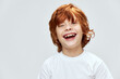 © SHOTPRIME STUDIO - Redhead boy smiles broadly close-up cropped view