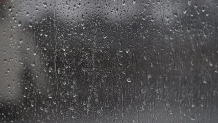 Wall Mural - Heavy rain real rain drops sliding on window glass in rainy season