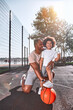 © Afshar Tetyana - Excited child and his father posing on basketball court