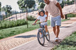 © Afshar Tetyana - Excited child learning cycle with a help of his dad