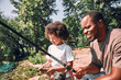 © Afshar Tetyana - Happy child and his dad fishing on beautiful day outdoors