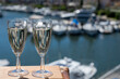 © barmalini - Summer party with sparkling champagne wine and sail boats haven of Port Grimaud on background, Provence, France