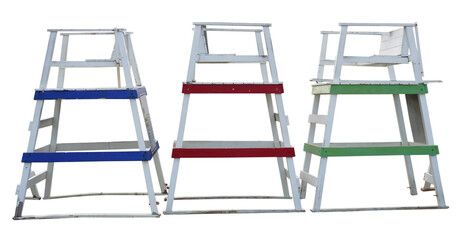 Wall Mural - Isolated weathered blue, red and green lifeguard towers standing idle in storage.