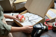 © insta_photos - Female online store small business owner seller holding gift packing package post shipping box preparing delivery parcel on table. Ecommerce dropshipping holiday presents sale concept. Closeup.